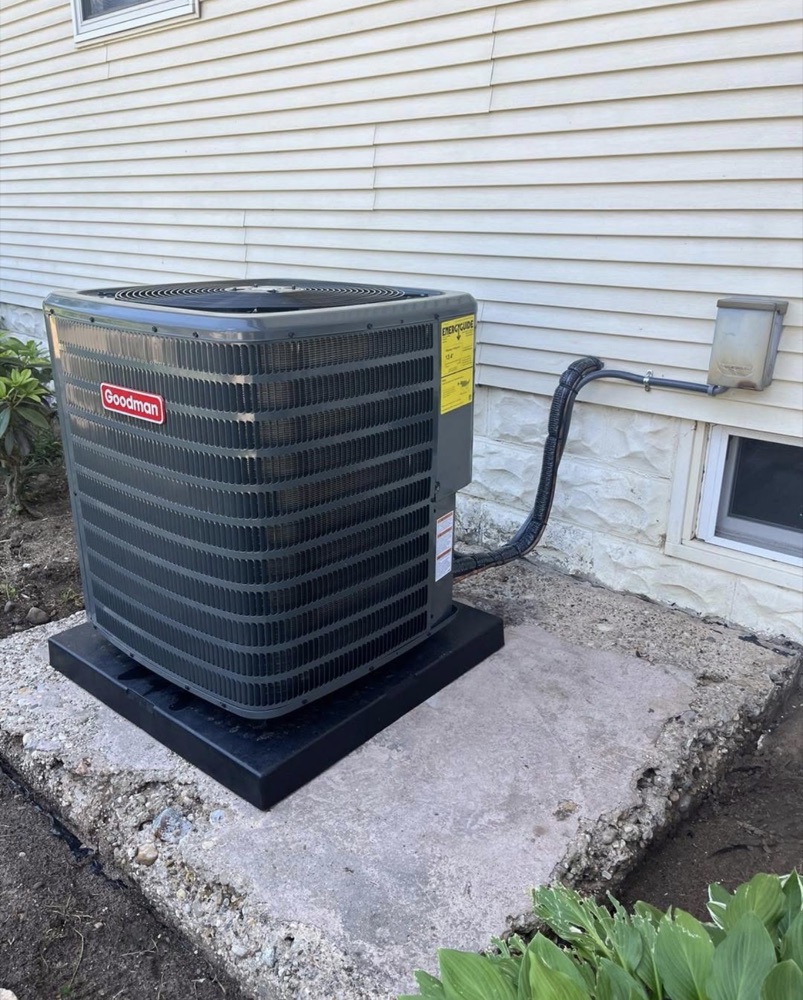 New Goodman outdoor AC condenser installed on a level pad at a Niles, MI area home