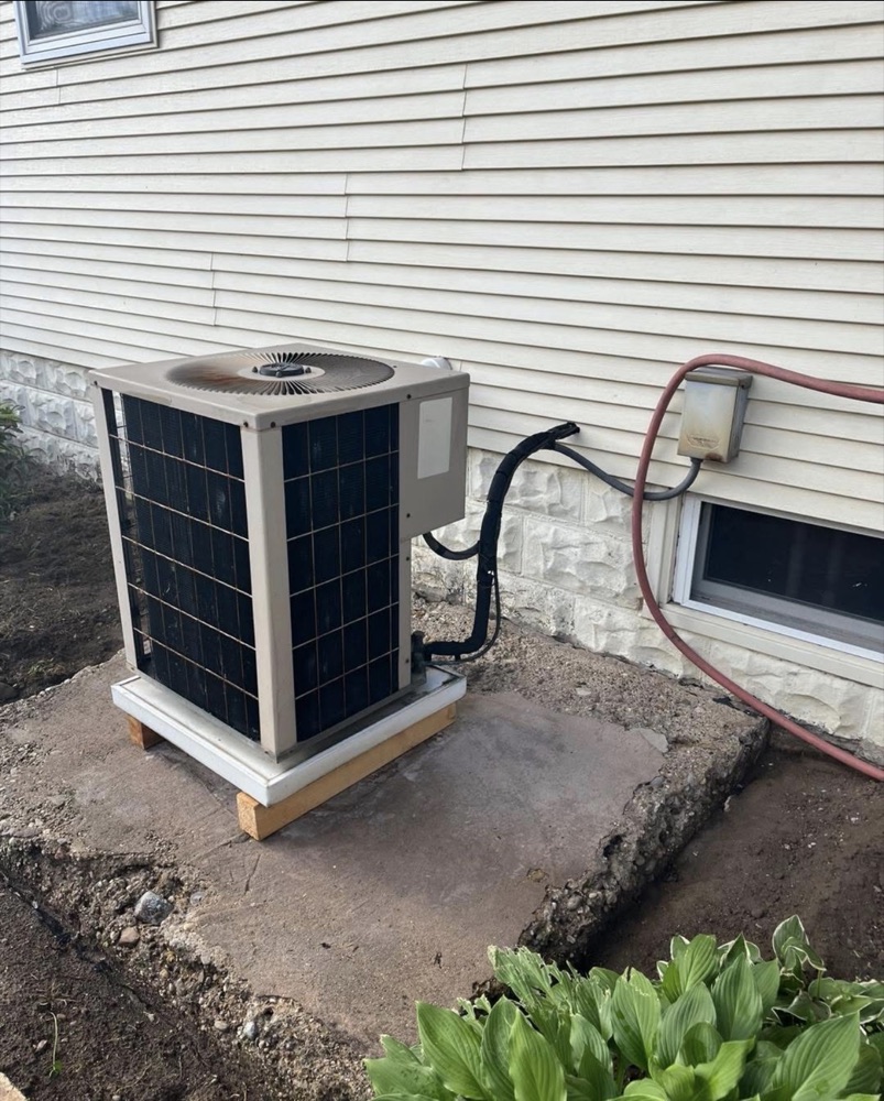 Old, rusted outdoor AC condenser before replacement at a Niles, MI area home
