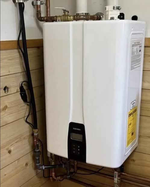 New wall-mounted Navien tankless water heater with clean copper piping in a Niles, MI area home